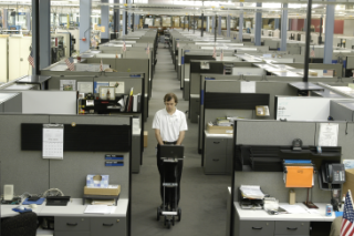 Using a Wireless Recon System, a SkyMark service engineer surveys wireless coverage and noise in an office building, with the cart tracking its location as it rolls and turns.